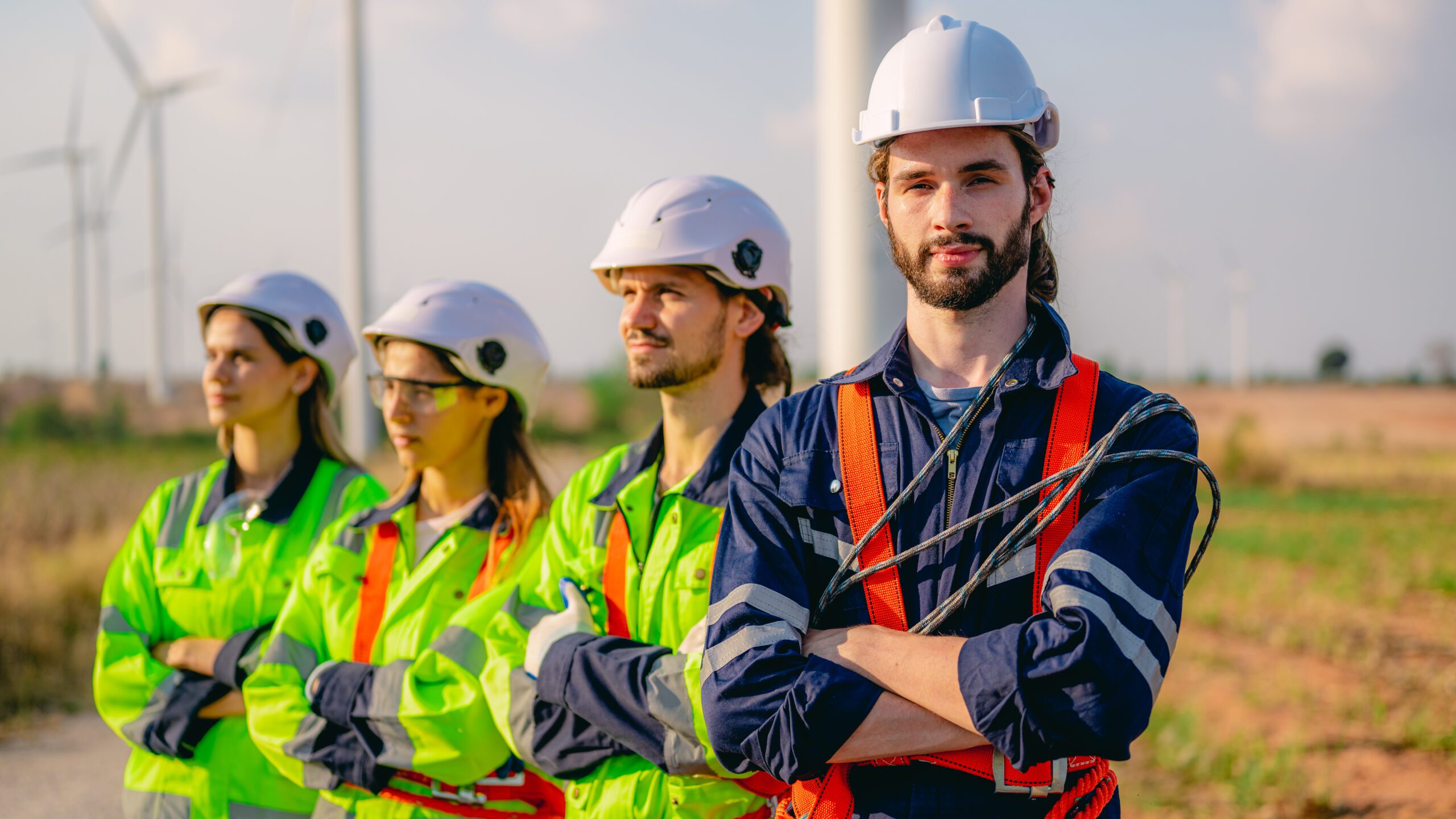 Professional engineer technician working outdoor at wind turbine field